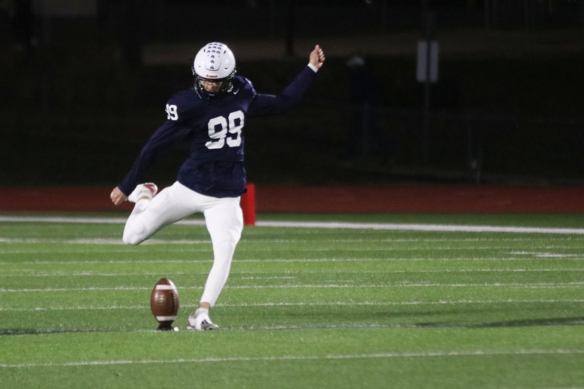 Eyes on the ball, senior Kenton Laughman prepares to kick.