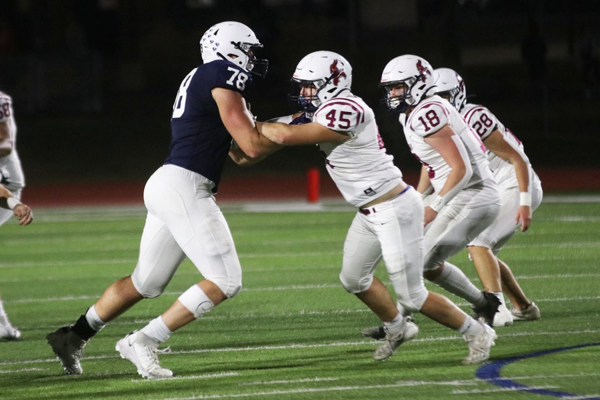 With his hands up, senior Gus Hawkins goes one on one with his opponent.