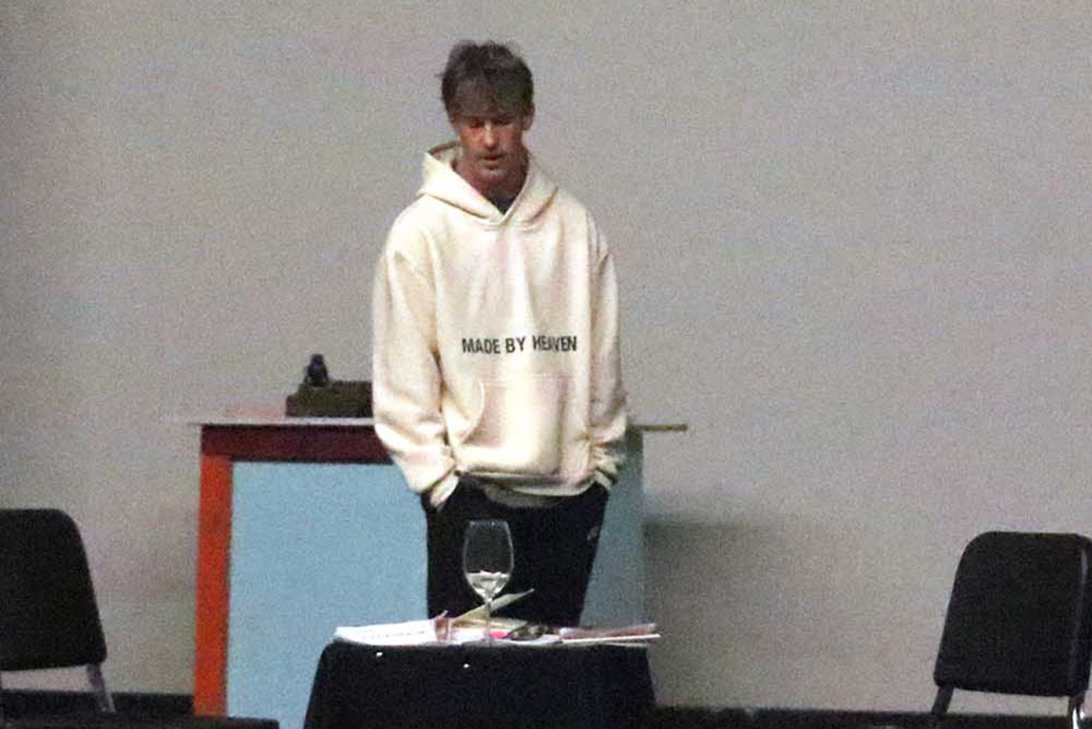 Standing on the stage, junior Cole Huffman talks about a verse from the Bible at an FCA meeting Friday, Nov. 17. 