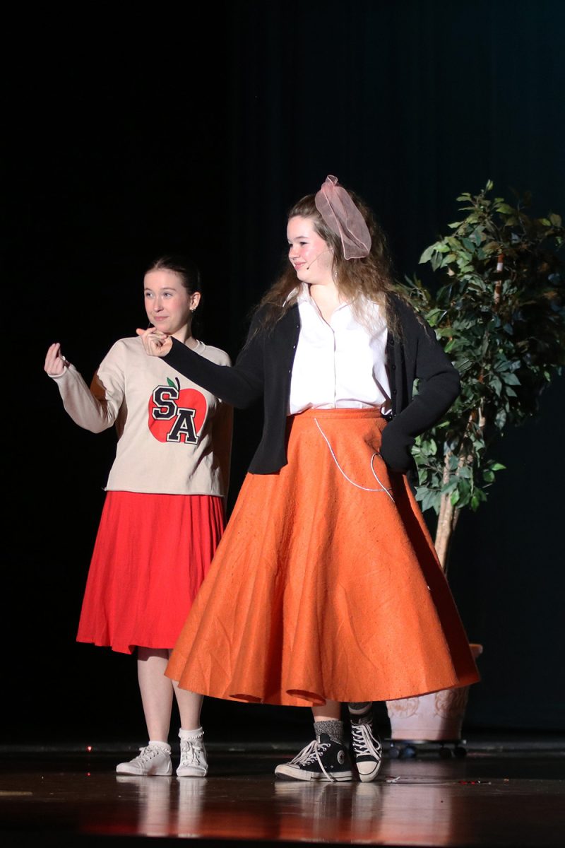 Ursula and Alice, played by junior Reese Miller and senior Maddy Olivier, snap their fingers and dance to “One Boy”.
