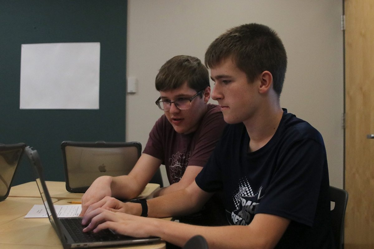 Participating in Battle of the Brains, sophomores Ian Weatherman and Carson Schmidtlein work on their new exhibit Friday, Oct.13.