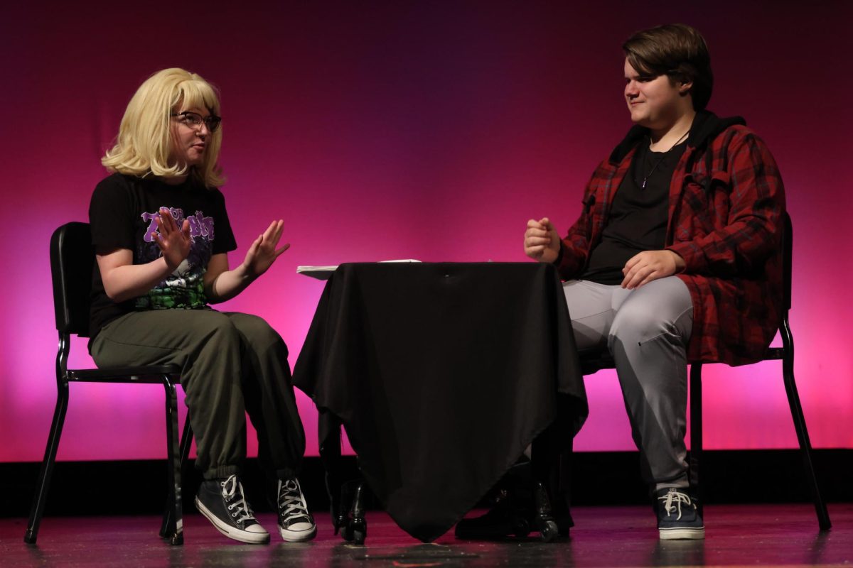 Junior Lilly Regenstein as Jackie throws her hands up in response to Guy, played by sophomore Scott Houghton