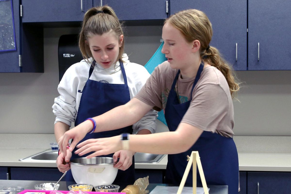 Freshmens Alexa Nightingale and Morgan Hennes makes a mix for their cheese balls.