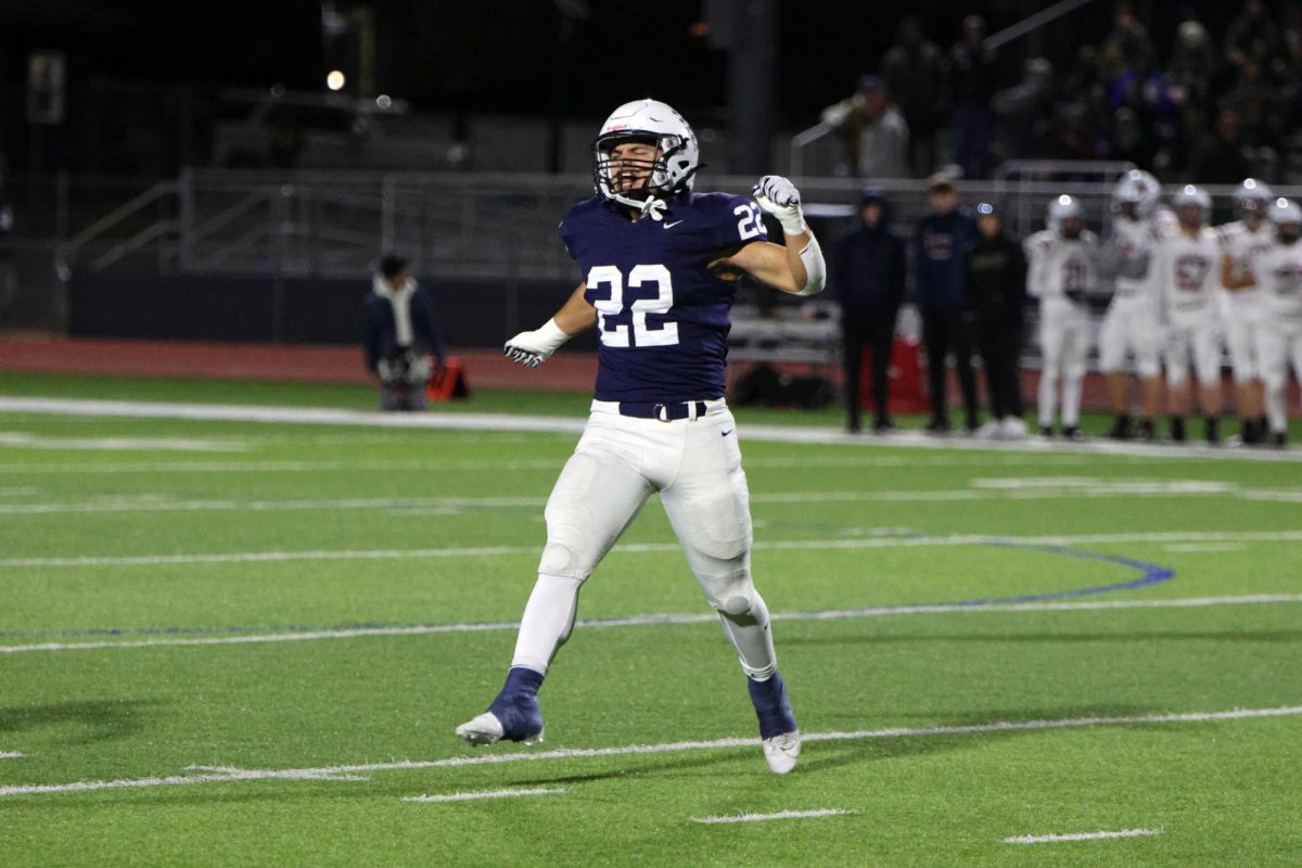 After the defense forced a fumble on the first play of the game, senior Evan Seifert gets the sidelines excited.