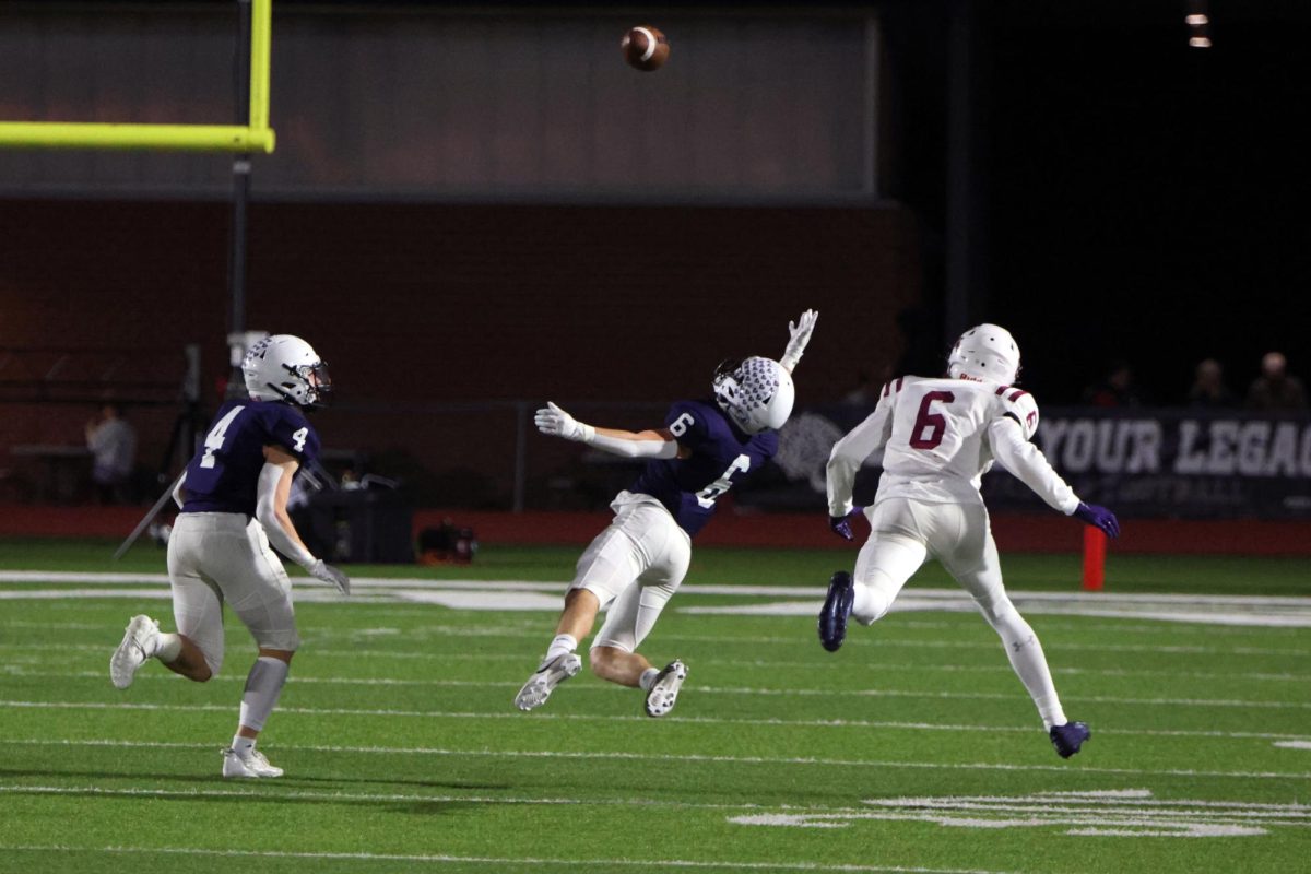 Diving to break up the pass, senior Jackson Lawler covers the opponent.