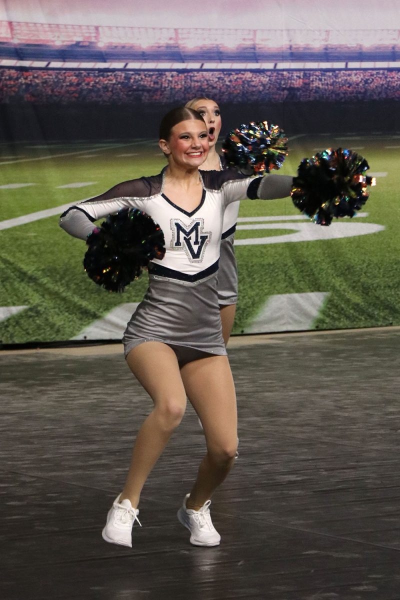 Poms in hand, sophomore Ella Jones performs in the Fight Song routine.

