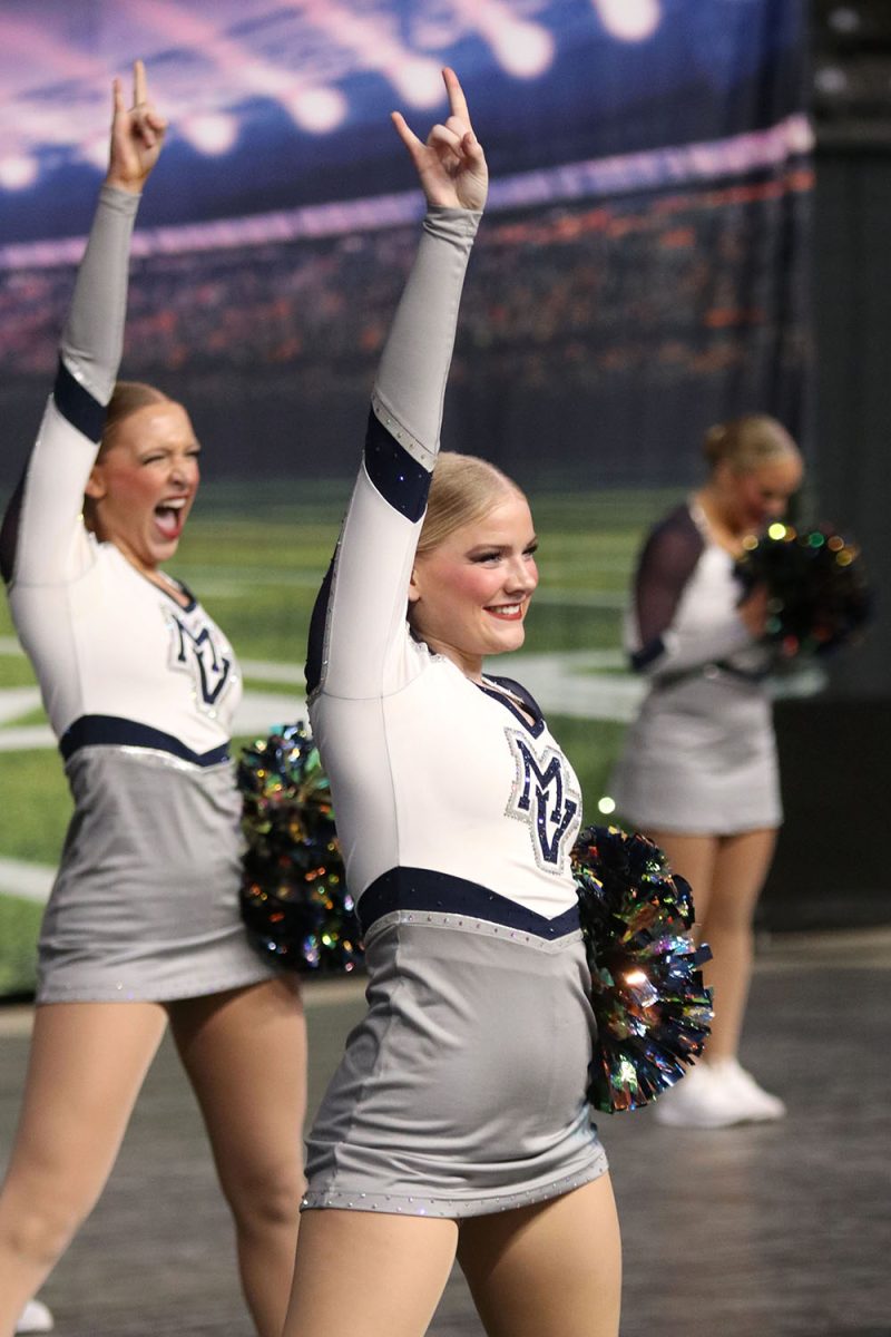 With her hand in the air, sophomore Sydney Lennon strikes a pose.
