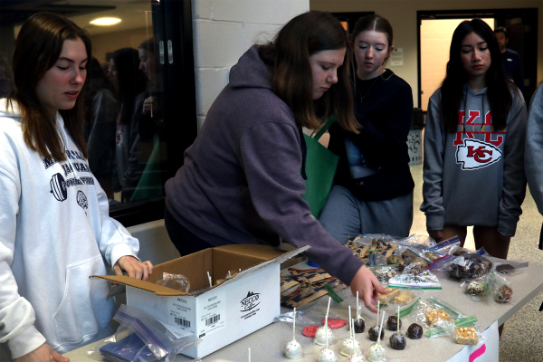 Juniors Piper Windler and Cadence Kerr sell baked goods such as cake pops and pumpkin bread with the help of their teammates. 