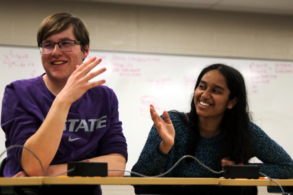 Sophomores Rachael Joseph and Ian Weatherman laugh as they hear the correct answer to a question.