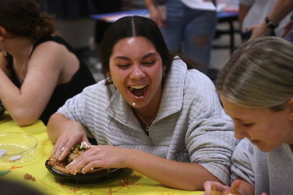 Having a blast, sophomore Stella Beins competes in a pie eating contest at clubsgiving.

