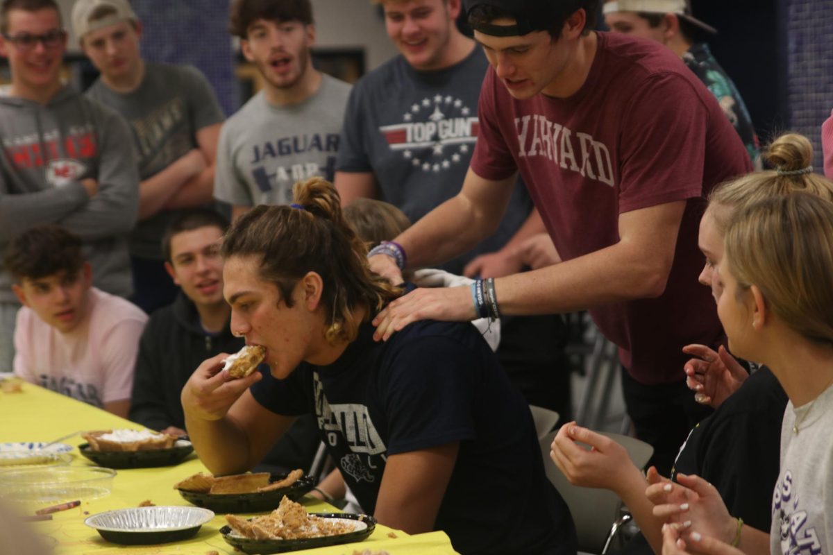 About to win the competition, senior Connor Bohon supports senior Sully Suderman before his win.