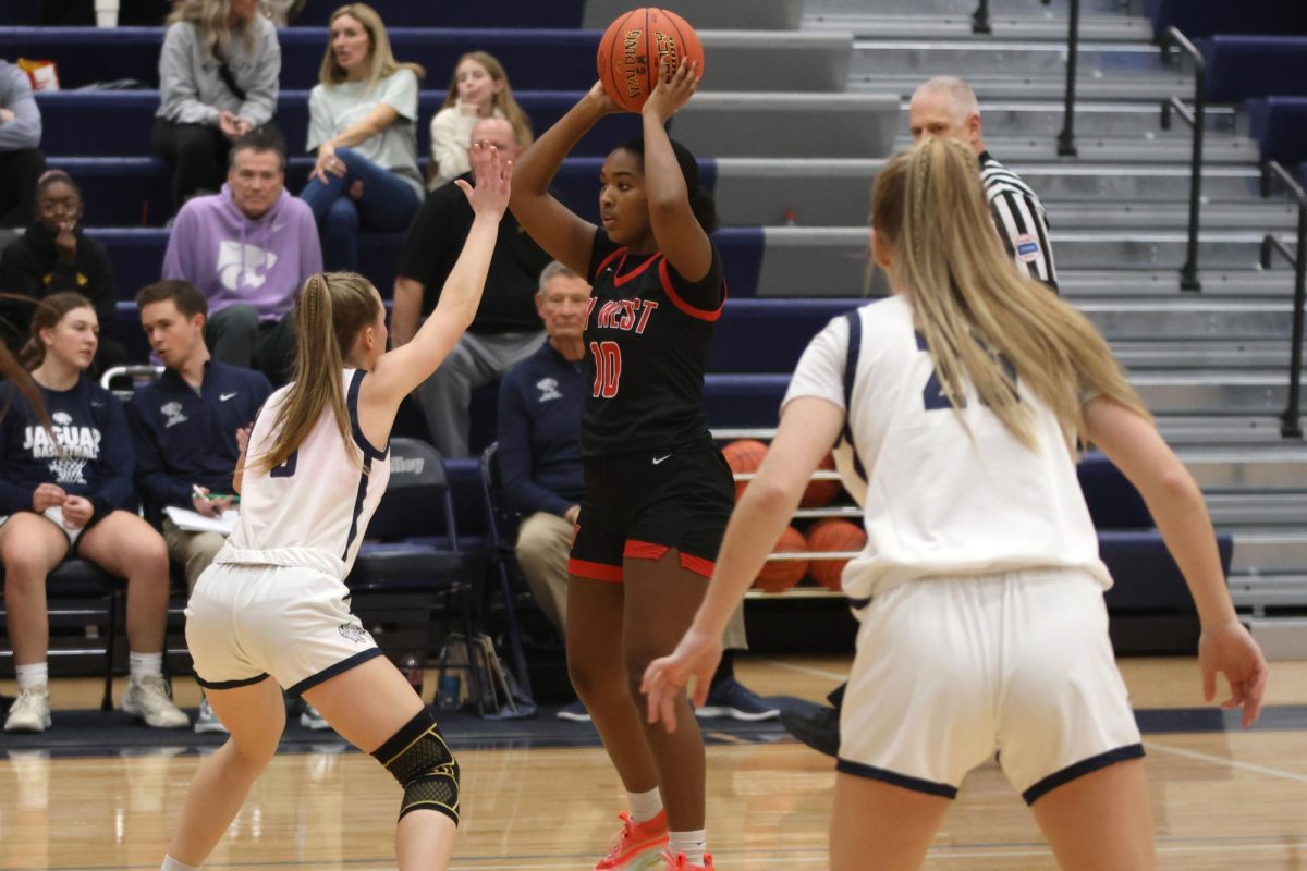 Junior Josie Benson puts a hand out while guarding her opponent 