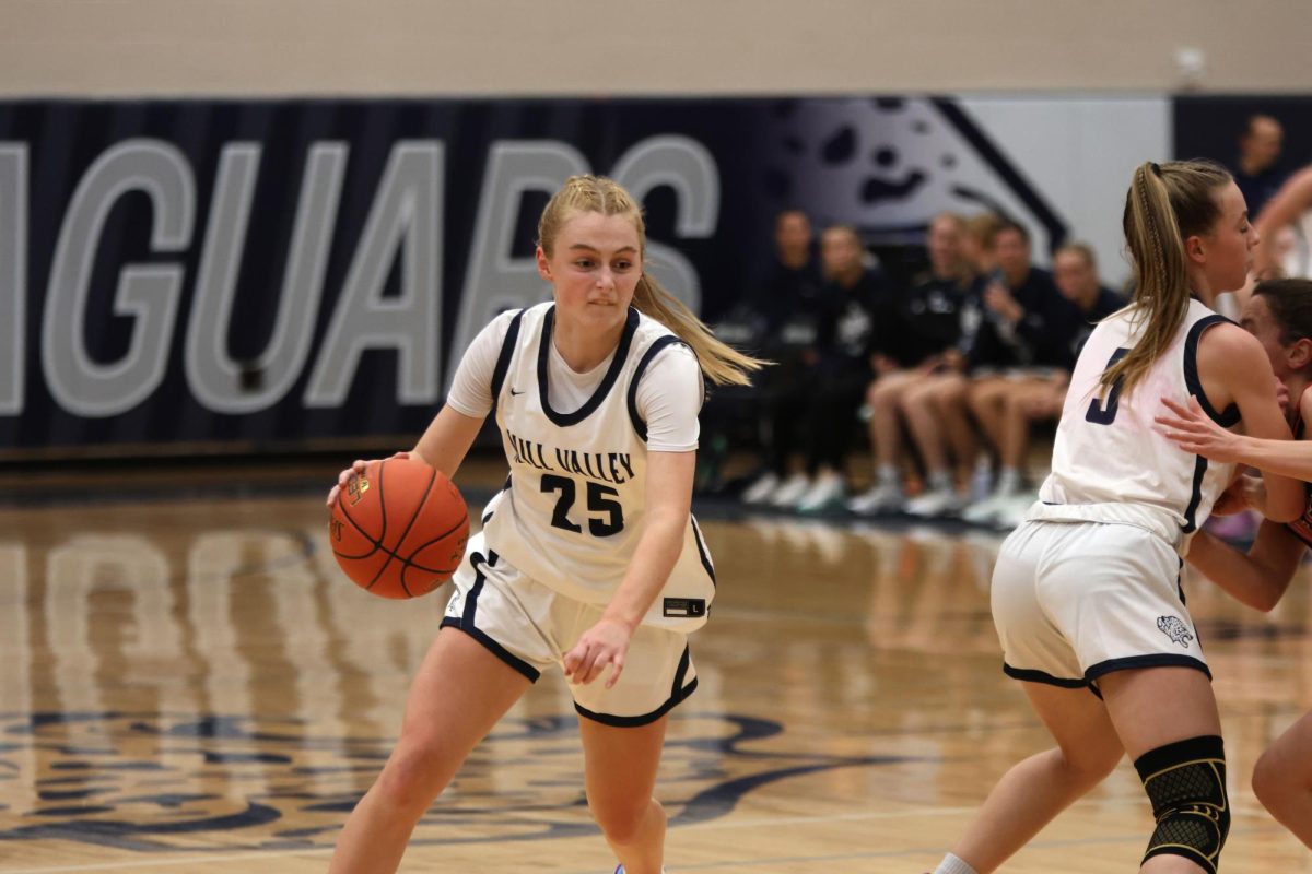 Junior Joseie Benson sets up a screen so freshman Riley Marshall can drive to the basket.