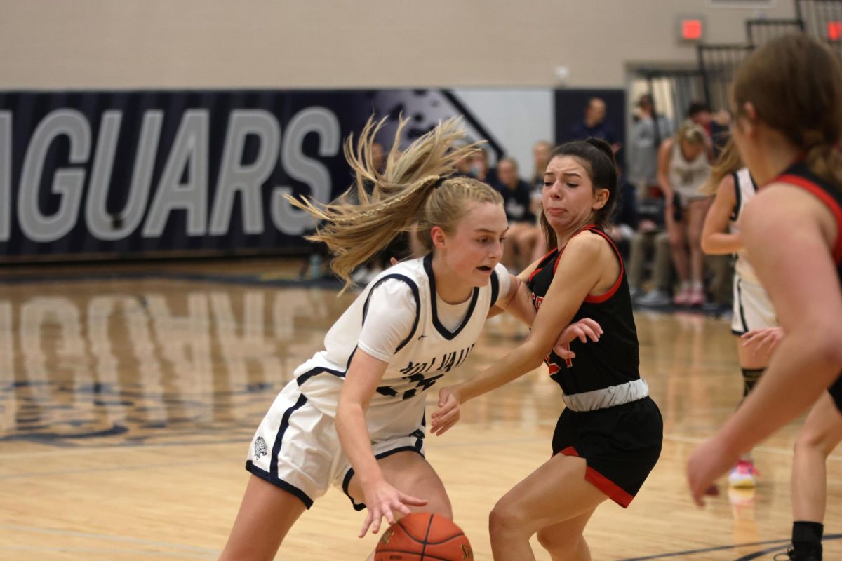 Freshman Riley Marshall uses a stiff arm to get around her opponent. 