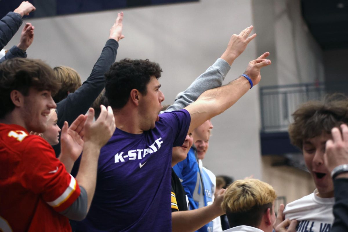 Senior Blake Neis holds up a three after Riely Riggs makes a three pointer.