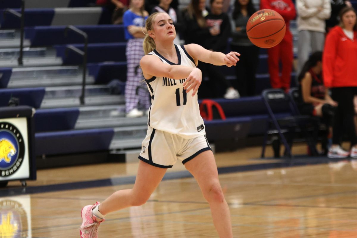 Freshman Riley Riggs pass the ball to a teammate.