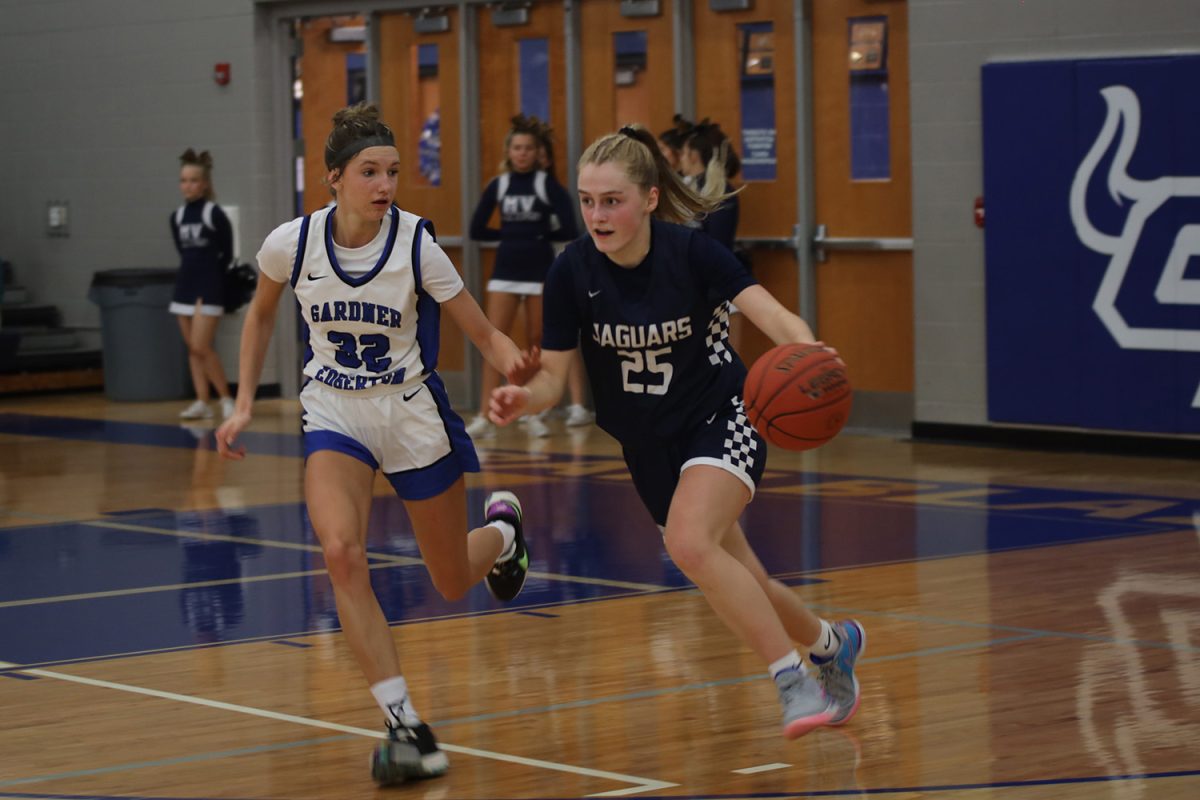 Looking ahead, freshman Riley Marshall attempts to rush past her opponent and towards the basket.