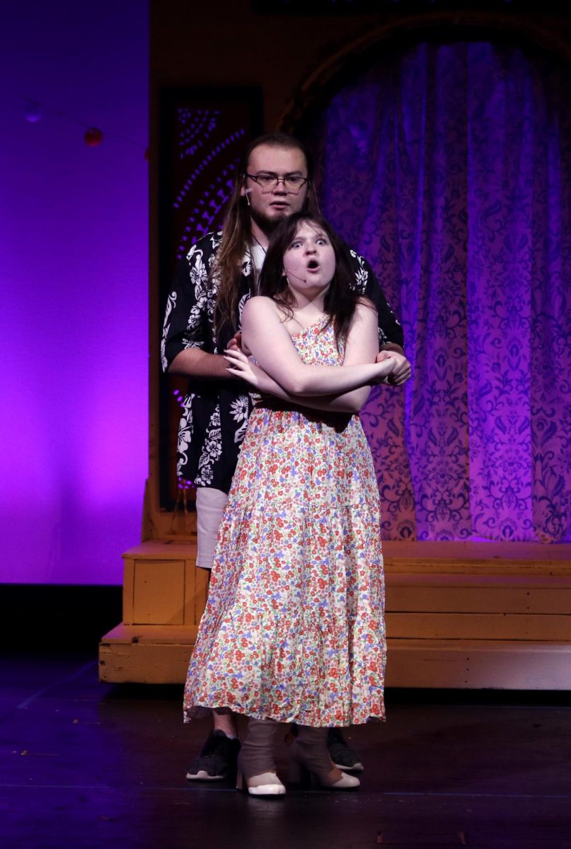 Holding hands, Bill and Rosie, played by seniors Aiden Ferguson and Kaelyn Russell dance along to “Take a Chance on Me.”