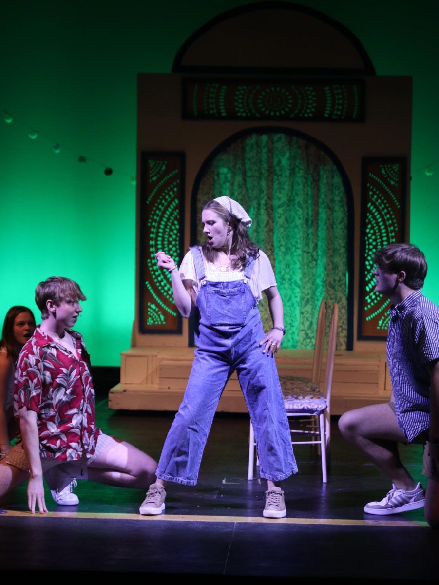 Looking down at Pepper, played by junior Logan Koester, Donna, played by senior Grace Cormany, sings and dances to “Money, Money, Money.”