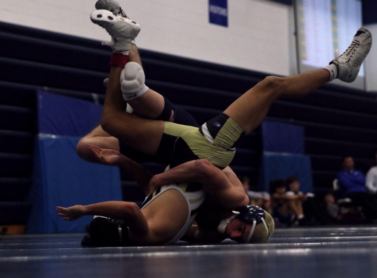 Upside down, senior Maddox Casella flips his opponent.