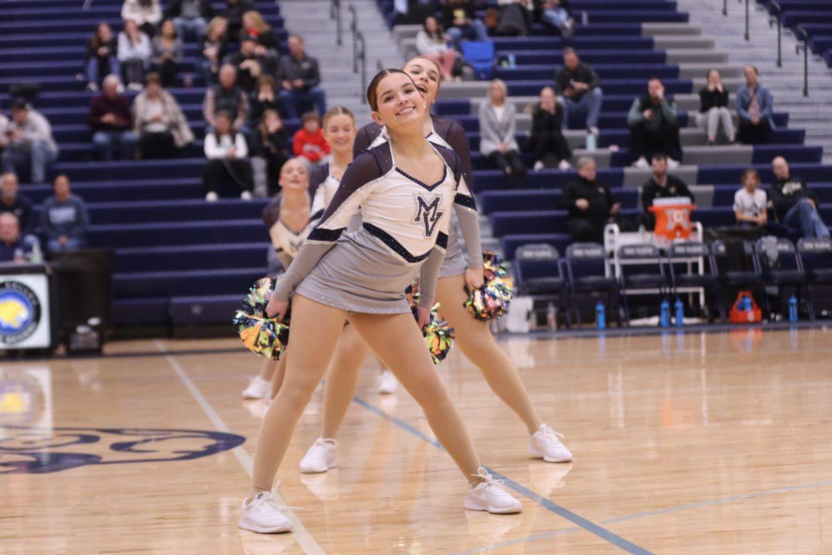 With a smile on her face, senior Keira Bret performs a dance at halftime.