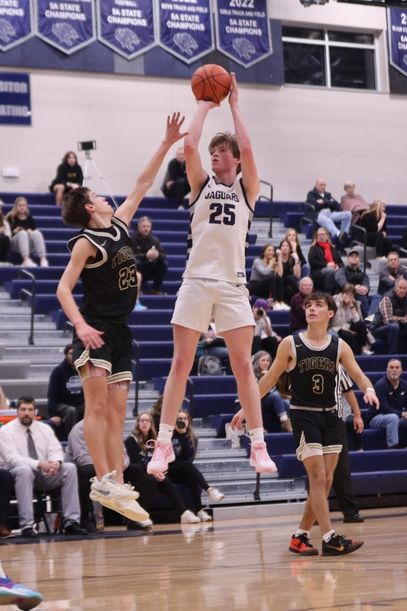 In mid-air, junior Carter Kaifes goes up for a jump shot against Blue Valley.