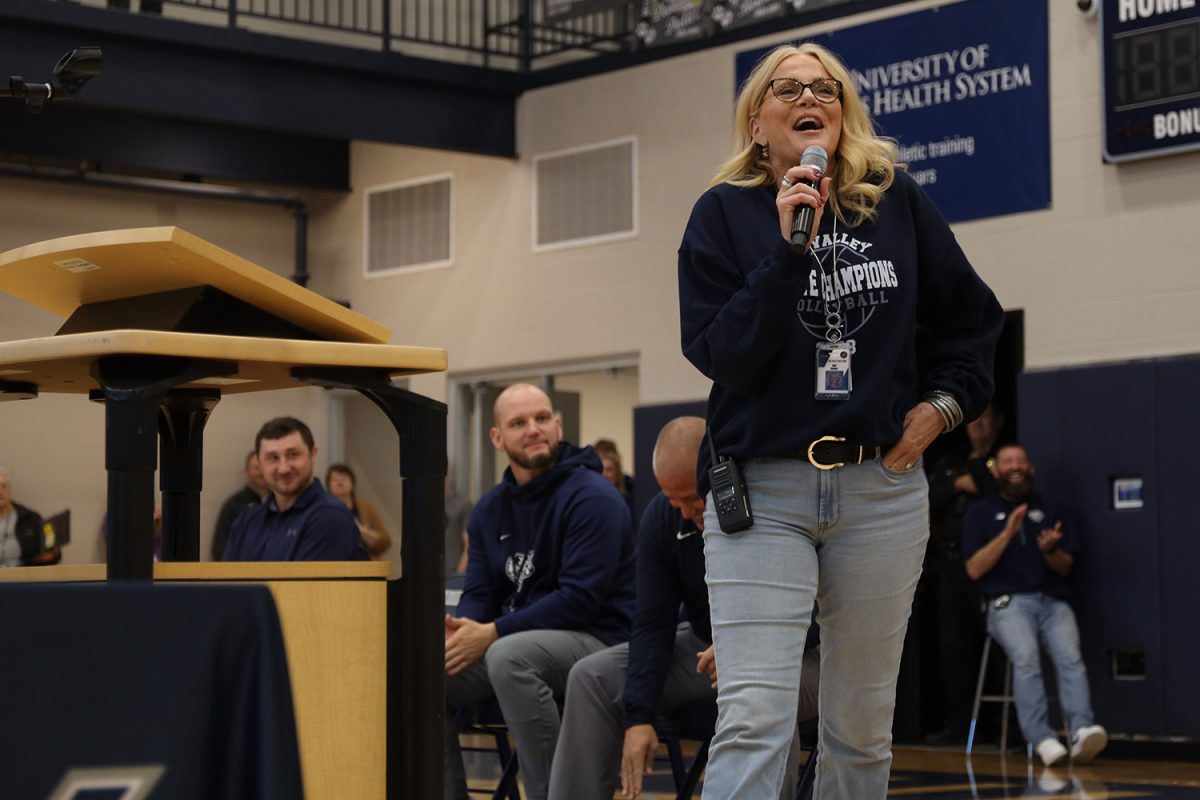 Smiling, [principal] Dr. Gail Holder says a final congratulations to the state winners to wrap up the assembly.