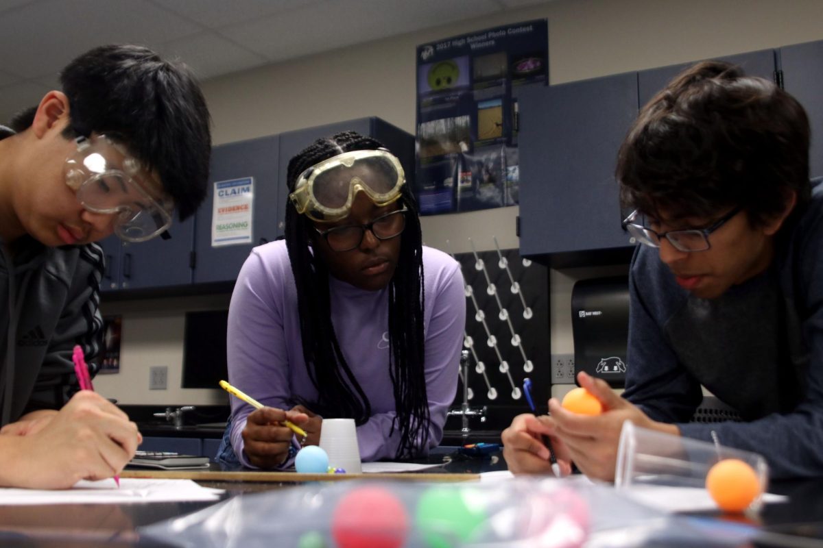 Junior Ian Chern, Sophomore Doreen Mahugu and Junior Shubh Patel work together for the Experimental Design event.