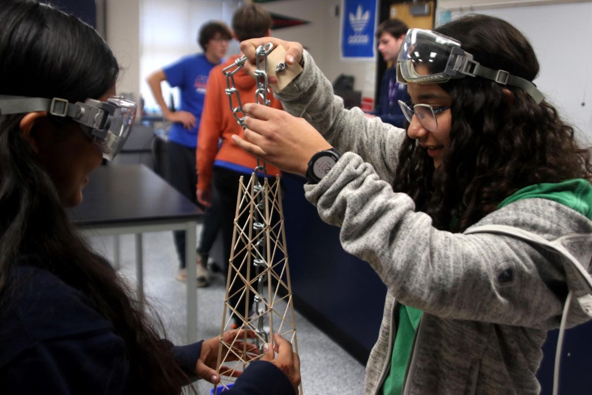 Competing students prepare their tower to be tested.