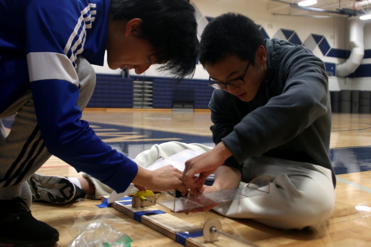 Blue Valley North students wind their aircraft to prepare for takeoff.