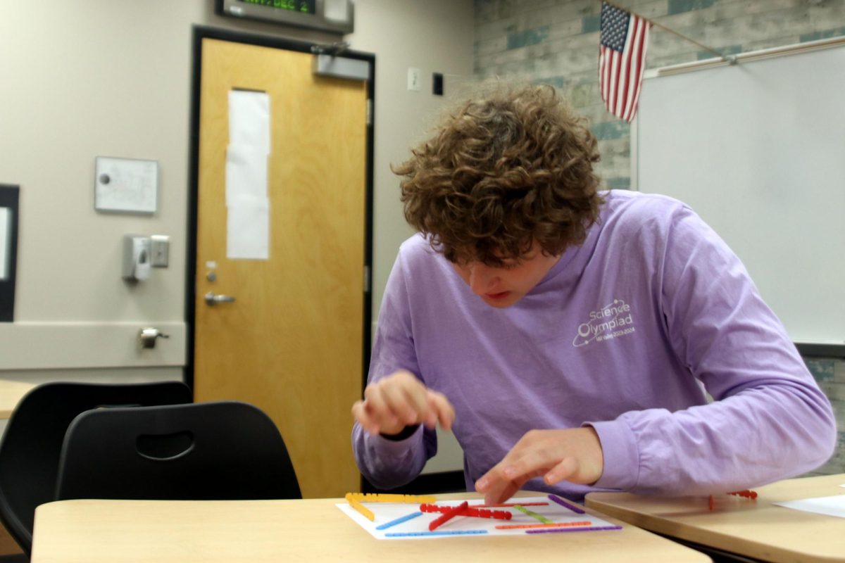 Junior Carter Tollman wraps up his finishing product for the Write It Do It event.
