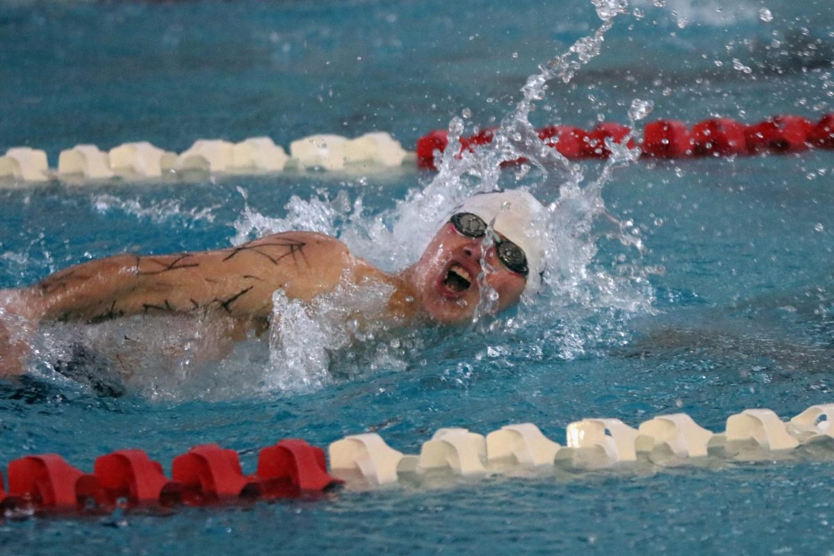 Turning his head to take a breath, senior Andre Arnold swims freestyle in the 500 yard descendo relay. 