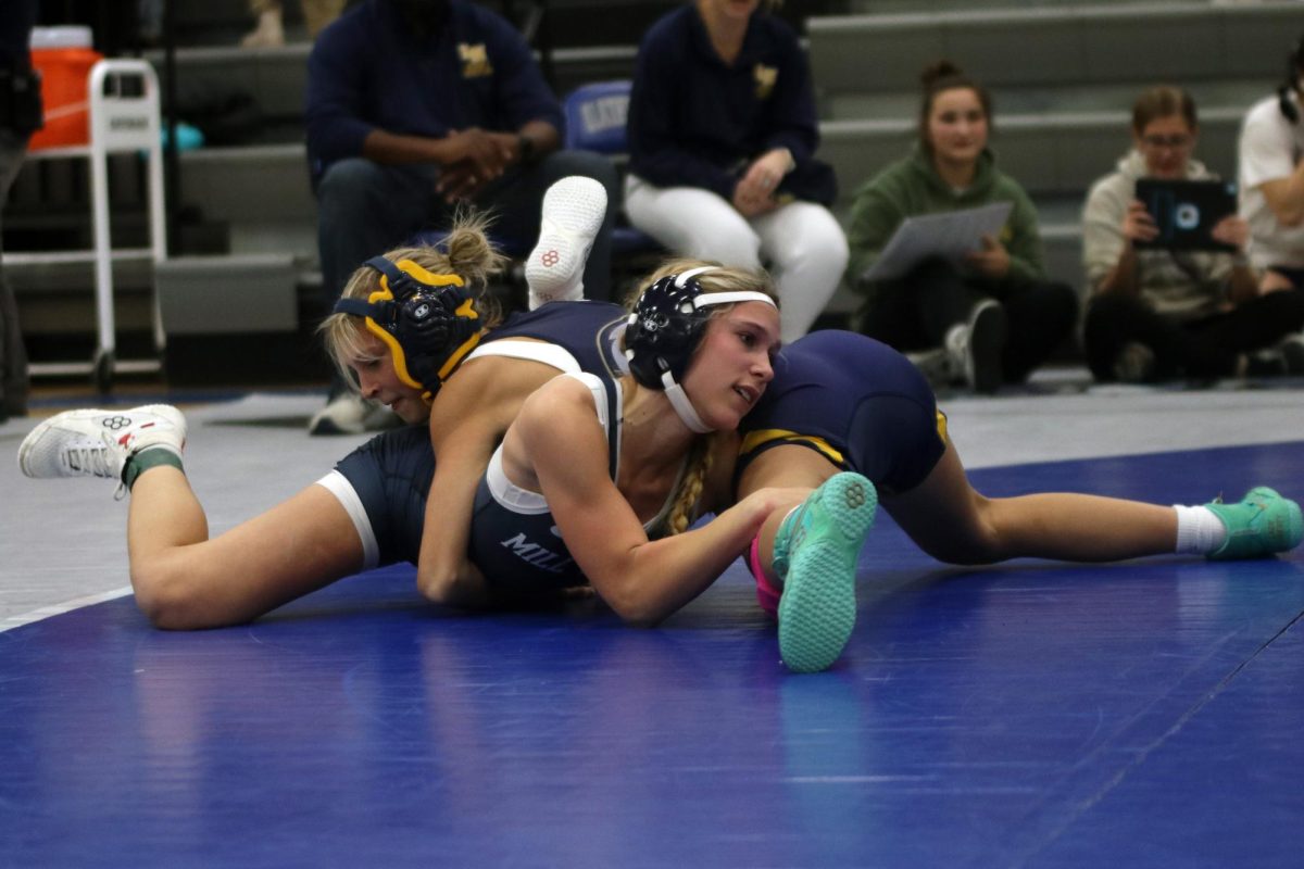 Focusing, junior Raina Frantz tries to get out from under her opponent. 