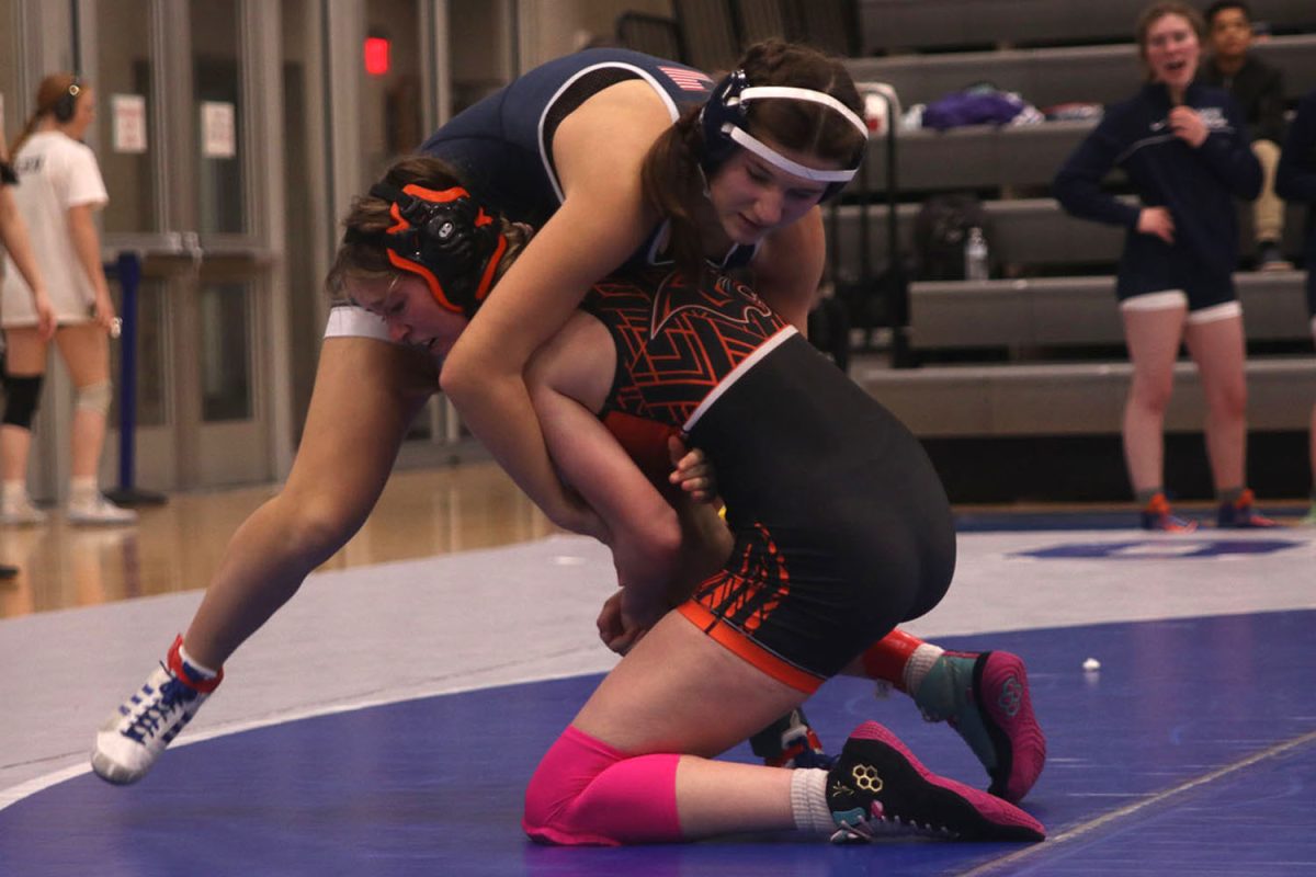 In her wrestling match, junior Jule Kohorst attempts to take down her opponent.