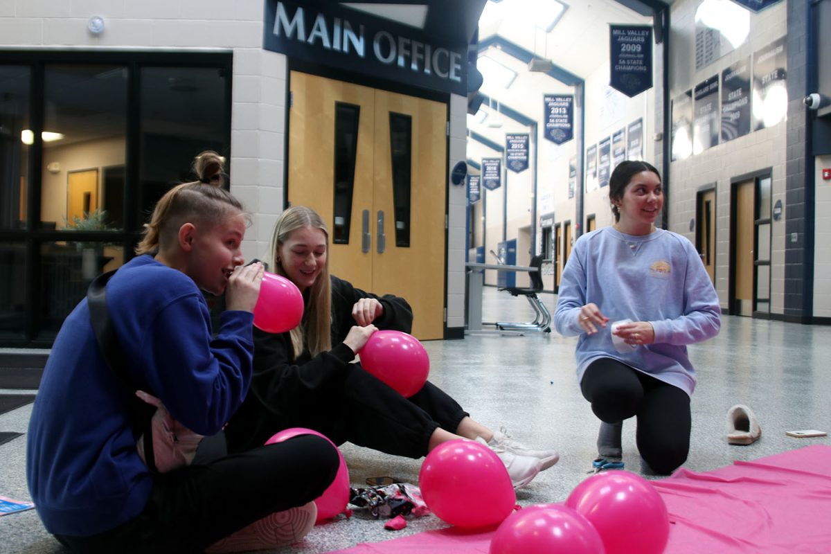 Preparing for Winter Homecoming, sophomores Sienna Suderman, Callaway Clifton, and Stella Beins blow up balloons for the Barbie selfie wall Sunday, Jan. 28