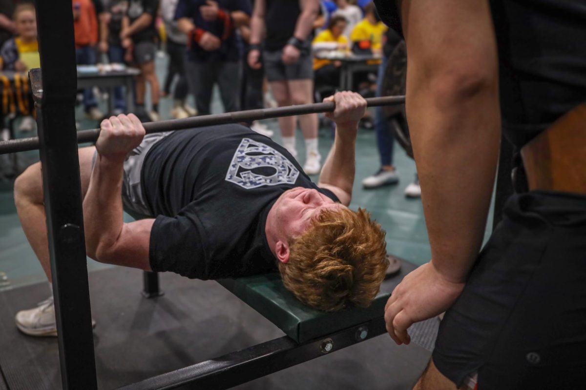 Pushing the bar off his chest, junior Conner Wood takes his final attempt at bench press.