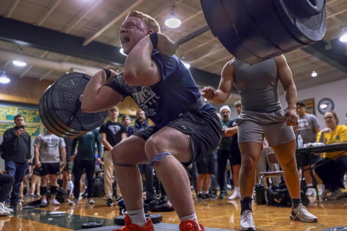 Using all of his strength, senior Waylon Schenk attempts a new personal best in hang clean.