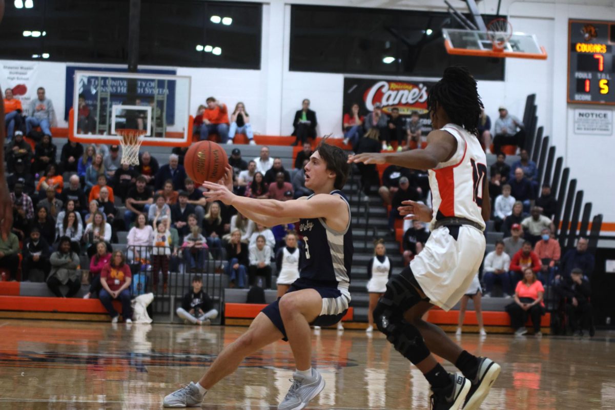 Senior Kael Drummond pass the ball to a teammate.