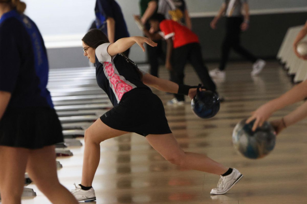 Focusing on the lane, senior Kiara Gonzalez throws her ball down towards the pins. 