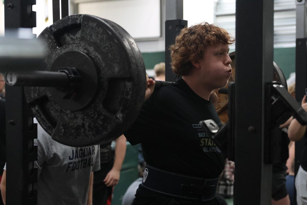 Calming his breath before his squat attempt, junior Aiden Lehr unracks his weight.