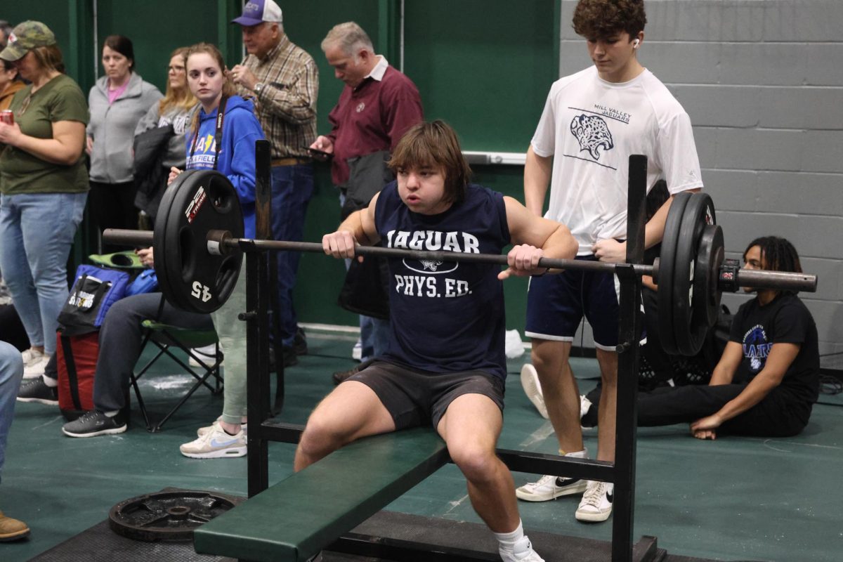 Preparing for his final bench attempt, freshman Nick Jenkins slows his breathing. 