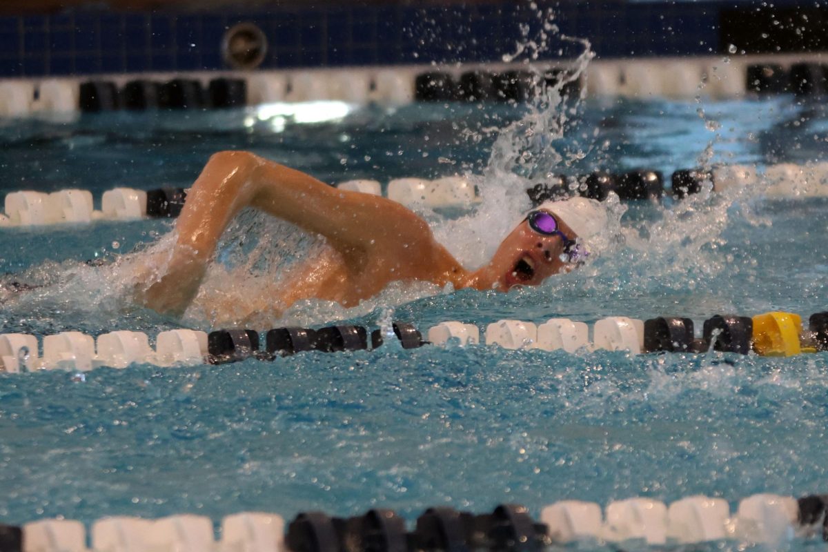 Turned to the side to take a breath, junior Alex Martin competes in the 200 yard freestyle.