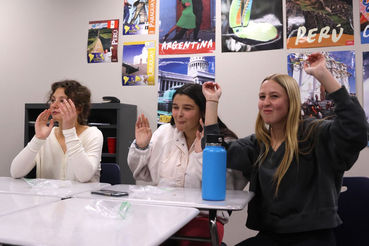 As the bell strikes twelve on the New Year’s clock, juniors Aislyn Whittmer, Celeste White and Maggie Wieland honor the new year at the Spanish National Honor Society meeting on Thursday, Jan. 11.