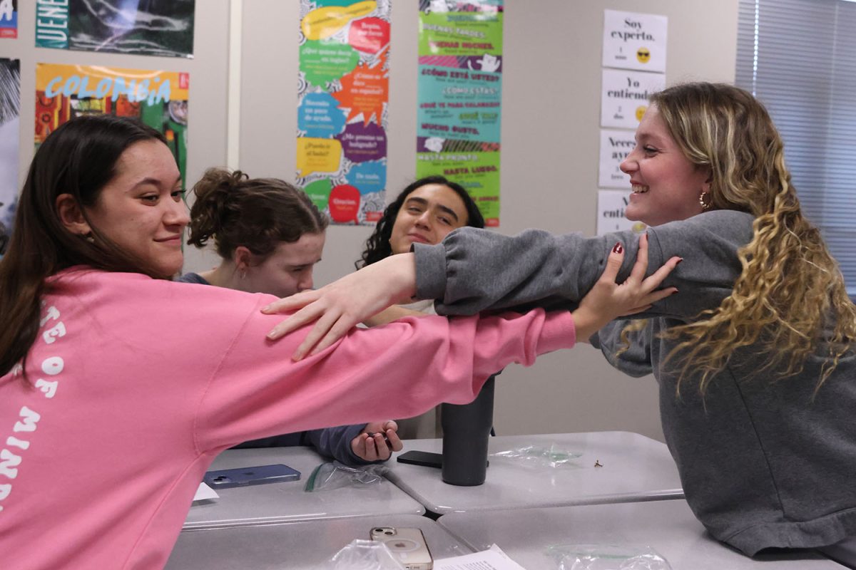 As they eat the twelfth of their grapes, one for each chime of the bell, Juniors Audri Brizendine and Julia Laws embrace in a traditional celebration at the end of the countdown to the new year.