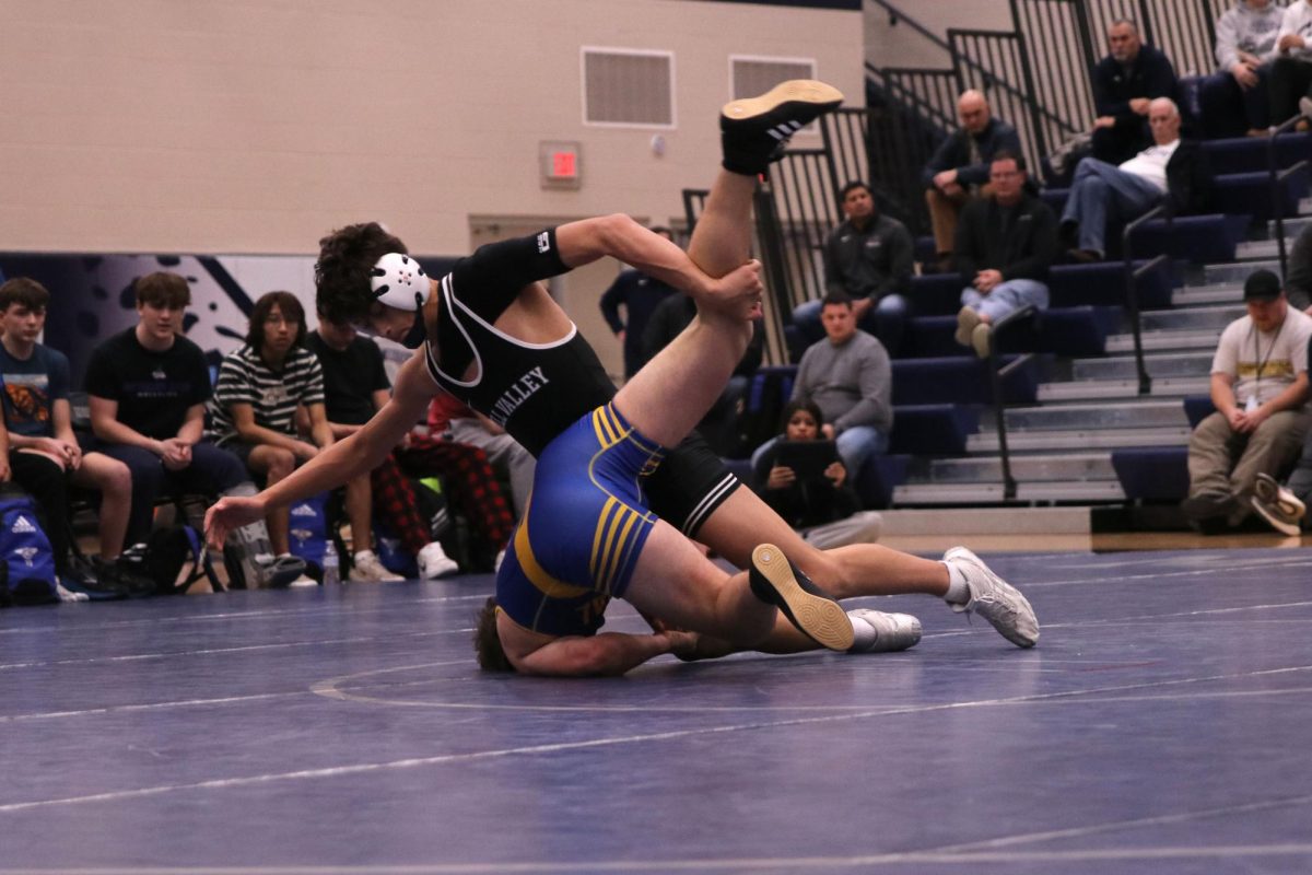 Grabbing his opponents leg, freshman Quinn Vaka attempts to flip his opponent over.