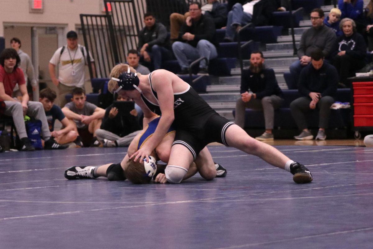 Holding his opponents head down, senior Robert Hickman prevents his opponent from getting up.