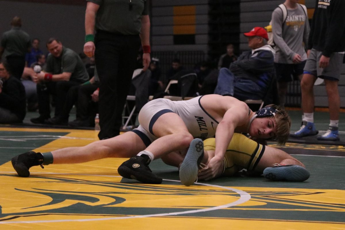 Searching for an ankle to control, senior Colin McAlister attempts to flip his opponent.  