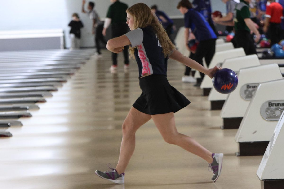 Pulling her arm back, sophomore Abby Haney throws the ball down the lane. 