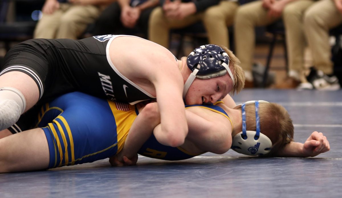 Laying on top of his opponent, senior Robert Hickman pins his opponent down to the mat.