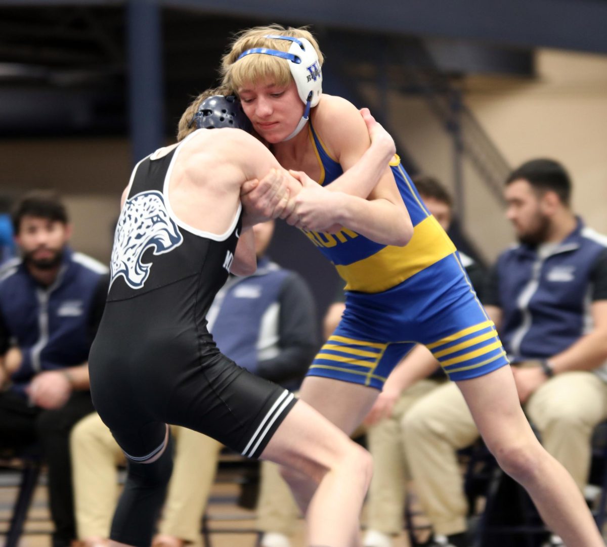 Holding his opponent back, sophomore Jeredy Nilges prevents his opponents from pushing out of the ring.